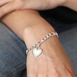 Model wearing Chunky Figaro Chain and Shell Heart Bracelet in Silver with hand on knee