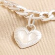 Close up of charm on Chunky Figaro Chain and Shell Heart Bracelet in Silver