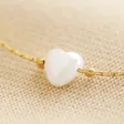 Close Up of Charm on Pearl Heart Charm Bracelet in Gold