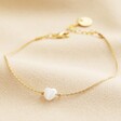Pearl Heart Charm Bracelet in Gold Full Length on Beige Material