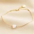 Pearl Heart Charm Bracelet in Gold Full Length on Beige Material