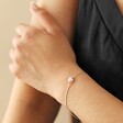 Model Wearing Pearl Heart Charm Bracelet in Silver with Hand on Arm