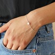 Model Wearing Pearl Heart Charm Bracelet in Silver with Hand in Pocket
