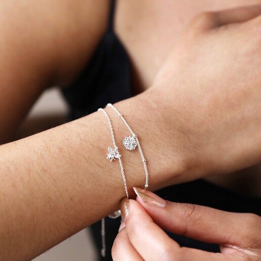 Model Wearing Set of 2 Daisy and Bee Chain Bracelets in Silver
