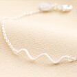 Close up of wavy charm on Wavy Lines Chain Bracelet in Silver