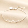 Wavy Lines Chain Bracelet in Silver on neutral coloured fabric