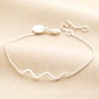 Wavy Lines Chain Bracelet in Silver on neutral coloured fabric