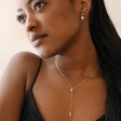 Model Wearing Crystal Moon and Star Lariat Necklace in Gold