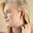 Molten Heart Huggie Hoop Earrings in Gold on Model