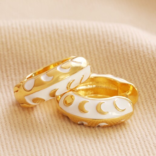 Moon Phase Enamel Huggie Hoop Earrings in Gold on natural coloured material