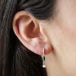 Close Up of Stone and Pearl Drop Huggie Hoop Earrings in Silver on Model