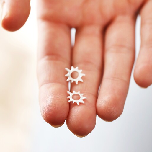 Model holding Sunbeam Stud Earrings in Silver in between fingers