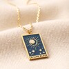 Close Up of Pendant on Enamel Blue Moon Tarot Card Pendant Necklace in Gold on Beige Fabric