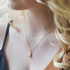 Model Wearing Feminine Figure Pendant Necklace in Gold