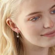 Model Looking to Side Wearing Molten Heart Huggie Hoop Earrings in Silver