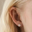 Close Up of Molten Heart Stud Earrings in Silver on Model