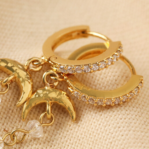 Close Up of Crystal Details Close Up of Crystal Details on Moon and Crystal Drop Chain Huggie Hoop Earrings in Gold