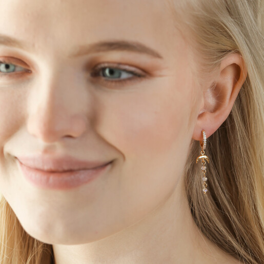 Earrings on Model Moon and Crystal Drop Chain Huggie Hoop Earrings in Gold on Model
