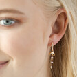 Model Wearing Moon and Crystal Drop Chain Huggie Hoop Earrings in Gold