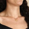Close up of Bee Oval Disc Pendant Necklace in Gold on dark haired model