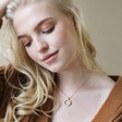 Blonde Model Wearing Celestial Semi-Precious Stone Pendant Necklace in Gold