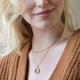 Blonde Model Wearing Celestial Semi-Precious Stone Pendant Necklace in Gold Layered with Chain
