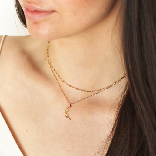 Colourful Crystal Crescent Moon Hammered Pendant Necklace in Gold on model in curated look