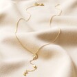Crystal Crescent Moon Lariat Necklace in Gold Full Length on Beige Material