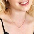Model smiling wearing Personalised Eternity Ring Pendant Necklace in gold