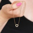 Model holding Eternity Ring Pendant Necklace in Gold in front