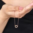 Model holding Eternity Ring Pendant Necklace in Rose Gold in front