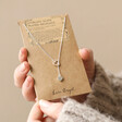 Model Holding Mismatched Heart Lariat necklace in Silver on Card