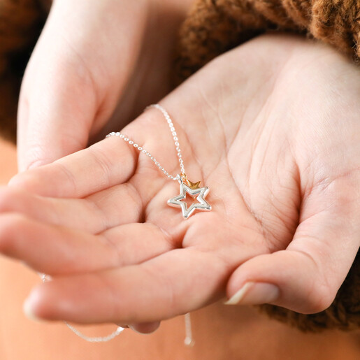 Model Holding Mixed Metal Double Star Necklace