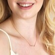 Model smiling wearing Pastel Baguette Crystal Bar Pendant Necklace in Gold