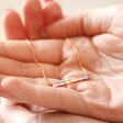 Model holding Pastel Baguette Crystal Bar Pendant Necklace in Gold in palm of hand