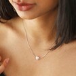 Close Up of Model Wearing Pearl Heart Charm Necklace in Silver