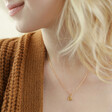 Model Wearing Smaller Heart From Set of 2 Friendship Heart Pendant Necklaces in Gold