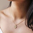 Close Up of Stamped Star Pendant Necklace in Gold on Model