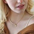 Close Up of Model Wearing Talisman Charm Pearl and Chain Necklace in Gold