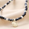 Talisman Moon Charm Beaded Necklace in Gold on Beige Coloured Fabric