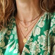 Model Wearing Mama Charm Necklace in Gold Layered With Other Gold Necklaces