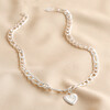 Thick Figaro Chain and Shell Heart Pendant Necklace in Silver on Beige Fabric