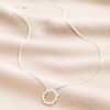 Wavy Lines Pendant Necklace in Silver full length on natural coloured material