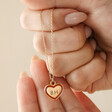 Model Holding Red Personalised Enamel Heart Pendant Necklace in Gold in Hands