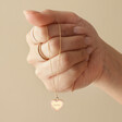 Model Holding Pink Personalised Enamel Heart Pendant Necklace in Gold in Hand