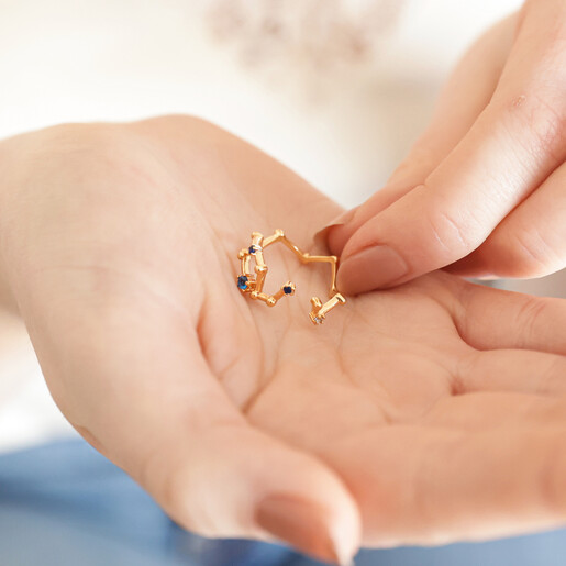 Model holding Adjustable Blue Crystal Constellation Ring in Gold in palm of hand
