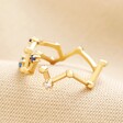 Adjustable Blue Crystal Constellation Ring in Gold From Different Angle on Neutral Fabric