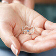 Model Holding Adjustable Blue Crystal Constellation Ring in Silver in Palm of Hand
