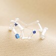 Adjustable Blue Crystal Constellation Ring in Silver on Beige Coloured Fabric