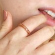 Close up of Adjustable Champagne Baguette Crystal Band Ring in Gold on model